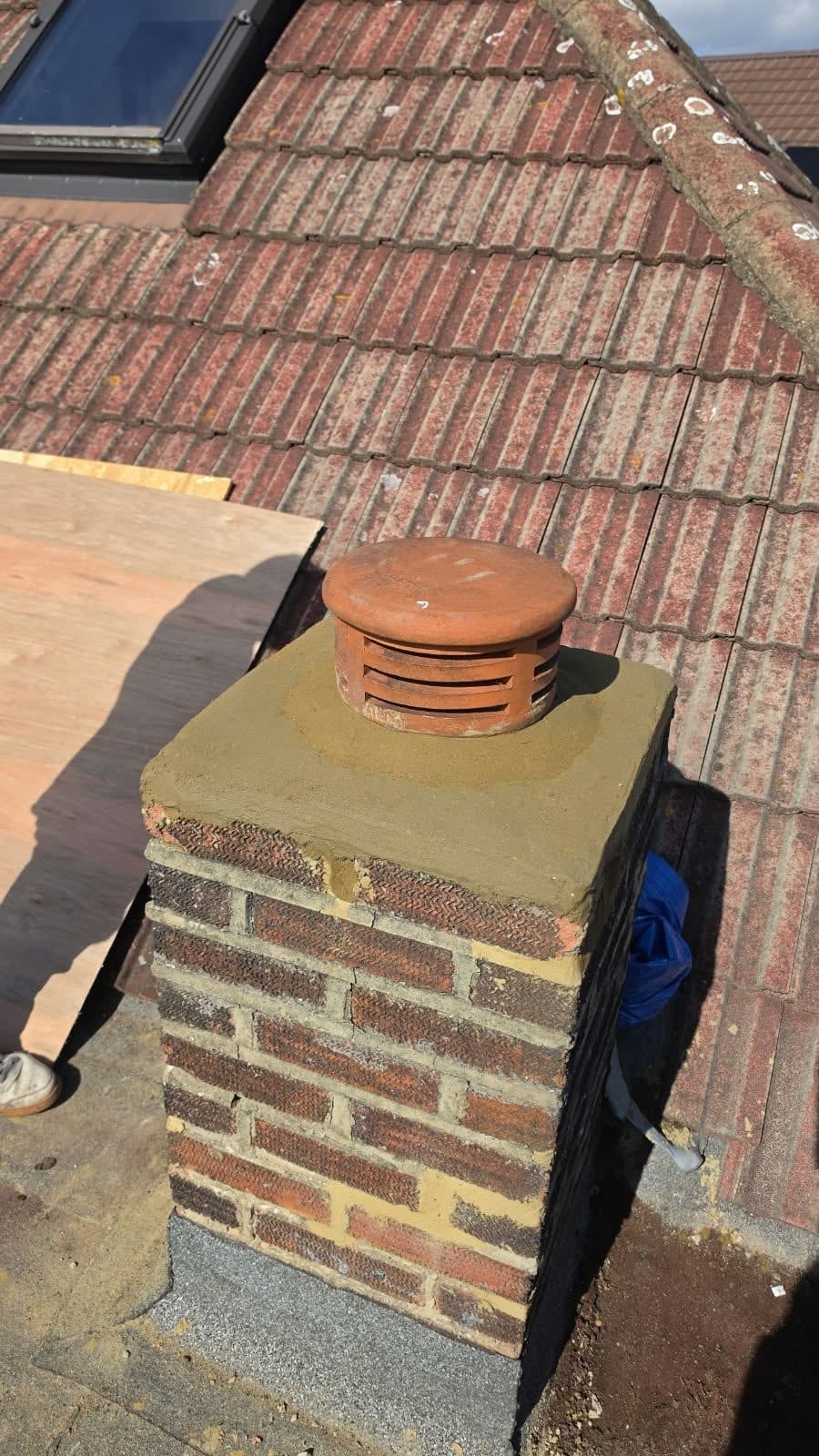 Rebuilt brick chimney with a new cowl